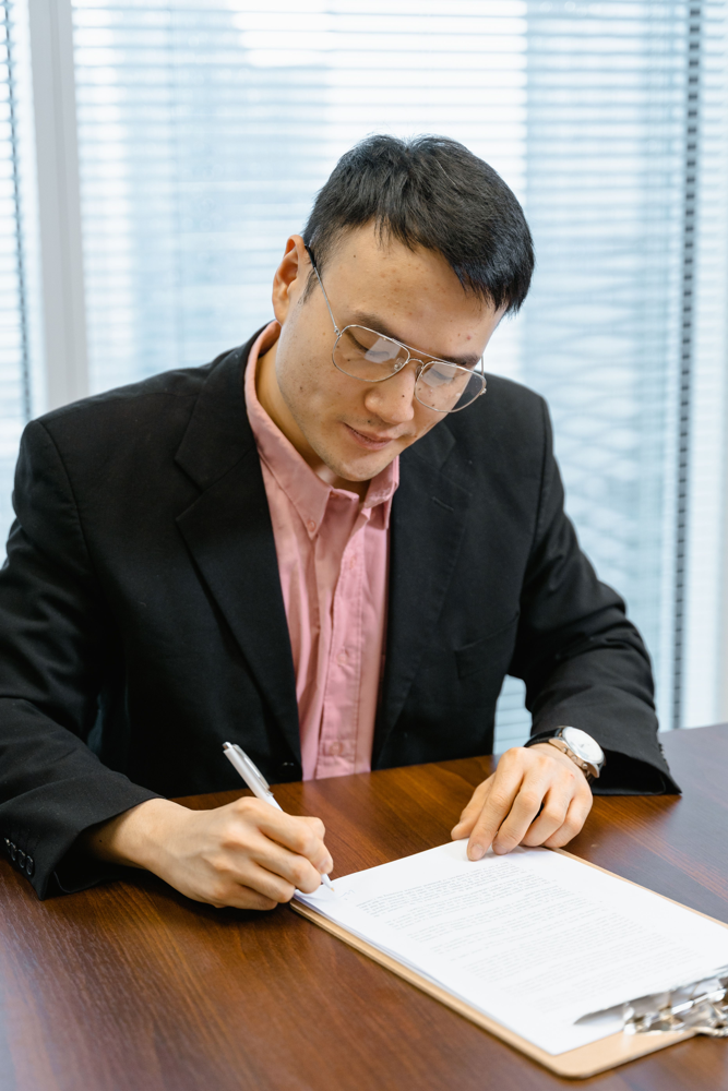 Asian professional signing legal documents